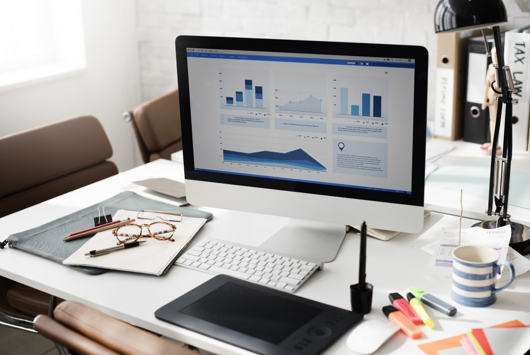 A workbench with a computer that displays graphs.